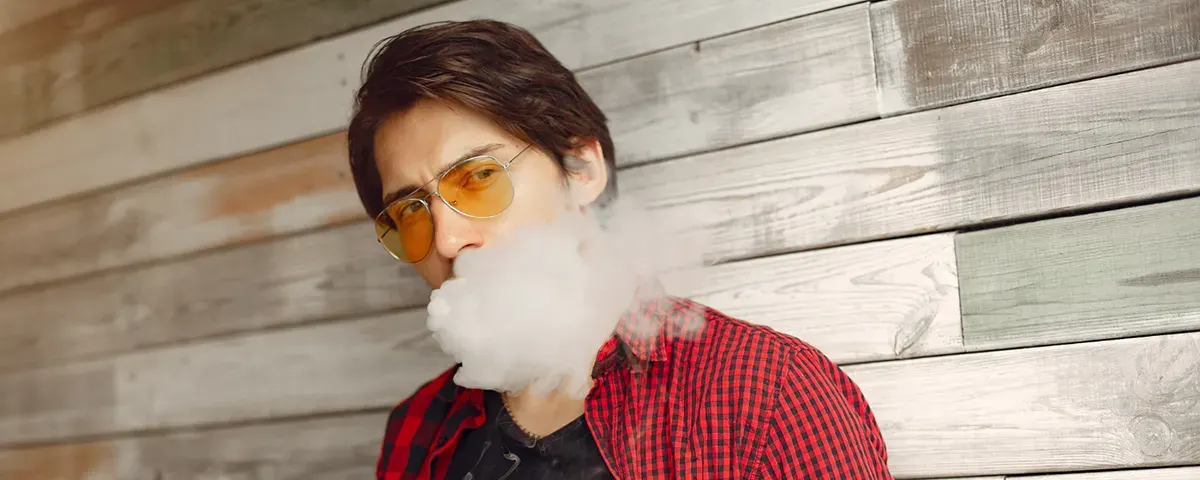 What Does It Mean When a Disposable Vape Blinks? stylish man with disposable vape