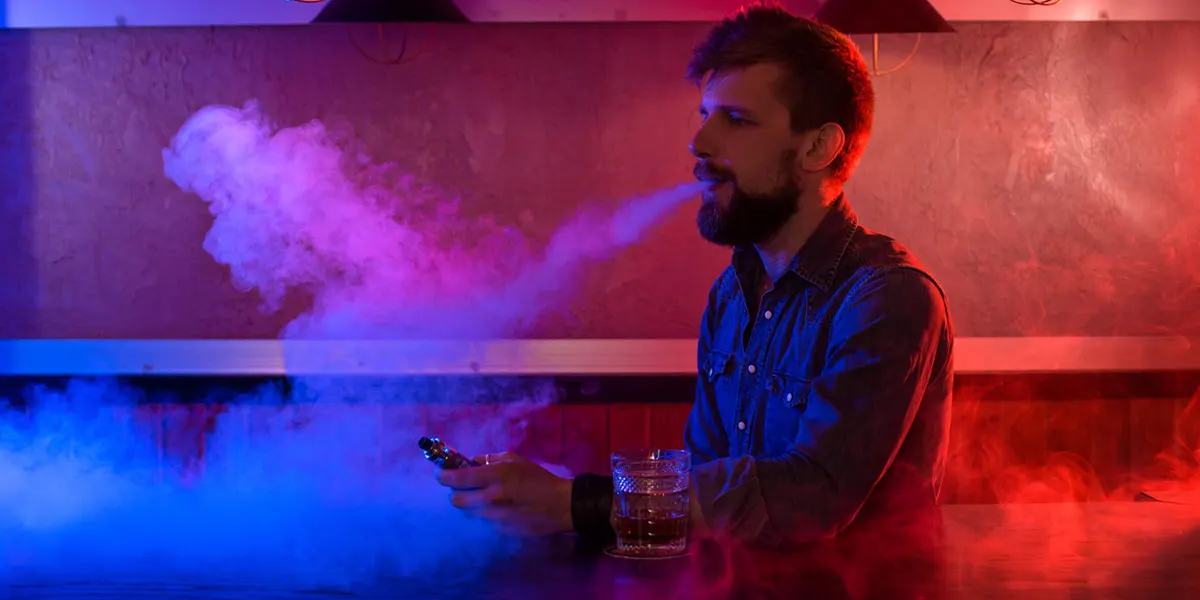 How to Make a Disposable Vape Work After It Dies man is vaping disposable vape before his vape dies