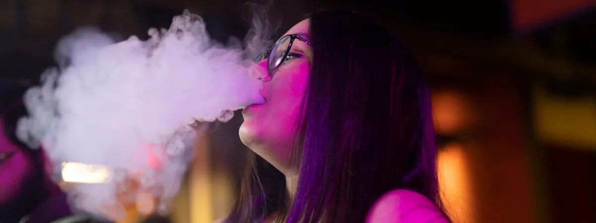 Why is My Disposable Vape Light Staying On? woman relaxing by vaping from active disposable vape