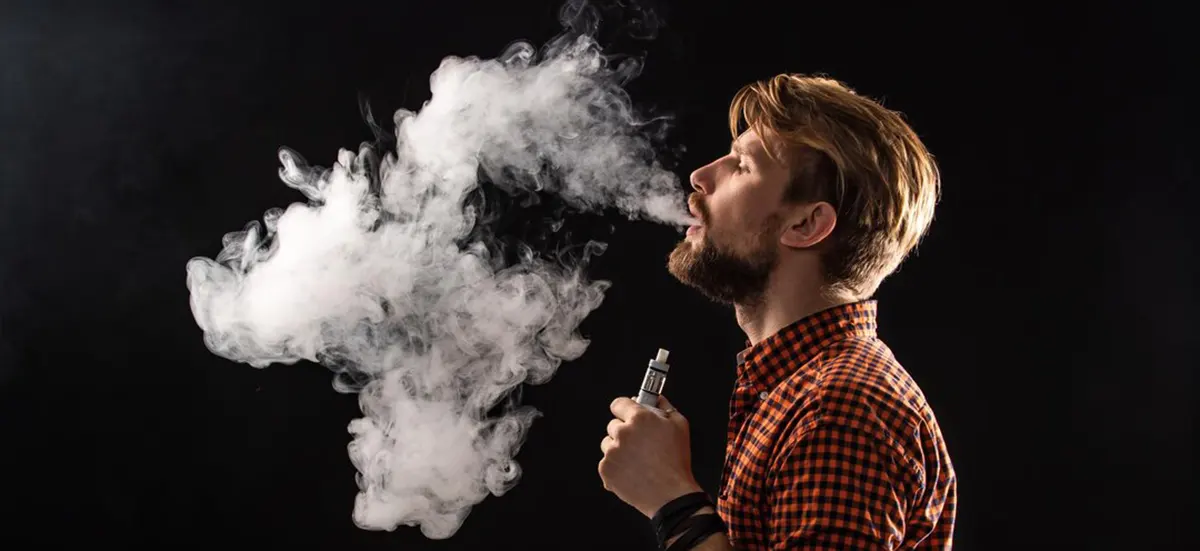 Why is My Disposable Vape Light Staying On? man with beard and stylish hairstyle enjoy vapor of disposable vape