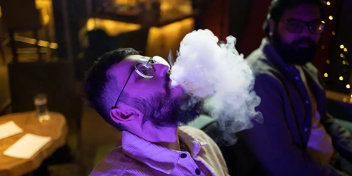 man relaxing by vaping with his friend from brand disposable vape